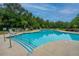 Inviting community swimming pool surrounded by lounge chairs and lush landscaping, perfect for relaxation and recreation at 112 Lake Jogassee Dr, Summerville, SC 29485
