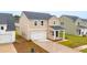 Newly constructed home with tan siding, attached garage and newly planted landscaping at 112 Moscato Ln, Summerville, SC 29485