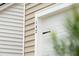 Close-up view of the house number and stylish white garage door at 112 Moscato Ln, Summerville, SC 29485