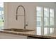 Granite countertop island features a stainless steel sink with a modern industrial faucet and lots of prep space at 112 Moscato Ln, Summerville, SC 29485