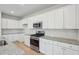 Open-concept kitchen showcases white cabinets, granite countertops, stainless steel appliances and a gas range at 112 Moscato Ln, Summerville, SC 29485