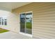 A covered patio with beige siding, a sliding glass door, and a view of an adjacent home at 112 Moscato Ln, Summerville, SC 29485