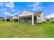 Home exterior featuring a screened-in porch and a lush green lawn at 117 Harbor Trace Ln, Summerville, SC 29486