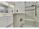 Bright bathroom featuring white cabinets, granite countertops, and tiled walk-in shower with seat at 117 Harbor Trace Ln, Summerville, SC 29486
