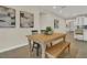 Charming dining area featuring a wooden table, bench, and eye-catching artwork at 117 Harbor Trace Ln, Summerville, SC 29486