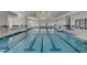 Well-lit indoor pool with multiple lanes and a separate spa area, perfect for year-round enjoyment at 117 Harbor Trace Ln, Summerville, SC 29486