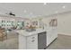 Elegant kitchen island with a stainless steel dishwasher and sink overlooking the living area at 117 Harbor Trace Ln, Summerville, SC 29486
