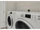 Laundry area featuring modern front-load washer and dryer with sleek digital displays at 117 Harbor Trace Ln, Summerville, SC 29486