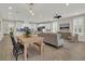 Bright, open-concept living room showcases modern kitchen and dining area with stylish decor at 117 Harbor Trace Ln, Summerville, SC 29486