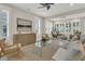 Comfortable living room area with a stylish glass table and many sun-filled windows with shutters at 117 Harbor Trace Ln, Summerville, SC 29486