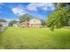 Large, grassy backyard featuring mature trees and a partial view of the home's exterior at 117 Myer Ln, Goose Creek, SC 29445