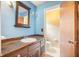 Bathroom with a sink, mirror, toilet, and a door to another room at 117 Myer Ln, Goose Creek, SC 29445