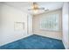 This bedroom has blue carpet, white walls, a ceiling fan, and a window with shutters at 117 Myer Ln, Goose Creek, SC 29445