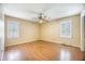 Bedroom featuring hardwood floors, a ceiling fan, and two shuttered windows at 117 Myer Ln, Goose Creek, SC 29445