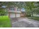 Two-story brick home boasts an attached two-car garage and red shutters at 117 Myer Ln, Goose Creek, SC 29445