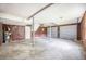 Spacious garage featuring a concrete floor, paneled walls, and two garage doors at 117 Myer Ln, Goose Creek, SC 29445