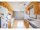 Bright kitchen with wood cabinets and view of the attached dining room with large window at 117 Myer Ln, Goose Creek, SC 29445