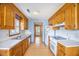 Bright kitchen with wood cabinets, laminate counters, and a view to another room at 117 Myer Ln, Goose Creek, SC 29445