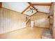 Living room with wood paneling, brick fireplace, vaulted ceiling, and hardwood floors at 117 Myer Ln, Goose Creek, SC 29445