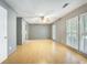 Bright living room featuring hardwood floors, neutral paint, and plantation shutters at 117 Myer Ln, Goose Creek, SC 29445