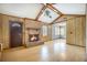 Spacious living room featuring a brick fireplace, wood paneling, and vaulted ceilings with exposed beams at 117 Myer Ln, Goose Creek, SC 29445
