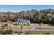 Aerial view of a spacious single-Gathering home with long private driveway surrounded by lush trees at 1174 Hitchfield Ln, Awendaw, SC 29429