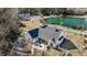 Stunning aerial view of a modern farmhouse with screened porch overlooking a serene lake and lush greenery at 1174 Hitchfield Ln, Awendaw, SC 29429