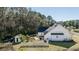 Outdoor space featuring a white fence, shed, and lush greenery at 1174 Hitchfield Ln, Awendaw, SC 29429