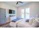 Comfortable bedroom featuring a white dresser, large windows, and cozy bedding at 1174 Hitchfield Ln, Awendaw, SC 29429