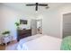 A serene bedroom with light walls, a dark wood dresser, and a ceiling fan at 1174 Hitchfield Ln, Awendaw, SC 29429
