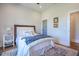 Inviting bedroom featuring a cozy bed with decorative pillows, hardwood floors, and ample natural light at 1174 Hitchfield Ln, Awendaw, SC 29429