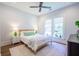 Cozy bedroom with green accents, a ceiling fan, and two bright windows that let in lots of light at 1174 Hitchfield Ln, Awendaw, SC 29429