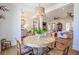 Elegant dining area with a round table, stylish chairs, and an open view to the living room at 1174 Hitchfield Ln, Awendaw, SC 29429