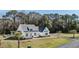 Inviting two-story home with a classic white exterior, dark roof, well-manicured lawn and driveway at 1174 Hitchfield Ln, Awendaw, SC 29429