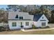 Charming two-story home boasts white siding, dark roof, and inviting front porch at 1174 Hitchfield Ln, Awendaw, SC 29429