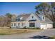 Inviting two-story farmhouse-style home with a welcoming front porch and well-manicured lawn at 1174 Hitchfield Ln, Awendaw, SC 29429