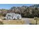 A charming two-story home with a well-manicured lawn and mature trees at 1174 Hitchfield Ln, Awendaw, SC 29429
