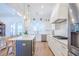Stylish kitchen boasts white cabinets, stainless steel appliances, a center island, and pendant lighting at 1174 Hitchfield Ln, Awendaw, SC 29429