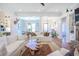 Bright living room boasts hardwood floors, white shiplap walls, and a unique wood coffee table at 1174 Hitchfield Ln, Awendaw, SC 29429