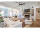 Open-concept living space features wood floors, comfortable seating, brick fireplace, and built-in shelving at 1174 Hitchfield Ln, Awendaw, SC 29429