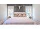 Close up on the bed with patterned pillows against a stylish paneled wall with a decorative cow skull at 1174 Hitchfield Ln, Awendaw, SC 29429