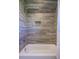 Modern shower with tiled walls, built-in niche, and bathtub at 1174 Hitchfield Ln, Awendaw, SC 29429