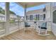 Relaxing porch view featuring rocking chairs and cushions, with a glimpse of neighborhood homes at 1182 Welcome Dr Dr, Mount Pleasant, SC 29464