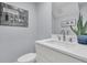 Bright bathroom features a modern vanity, stylish mirror, and a unique framed vintage golf-themed art print at 1182 Welcome Dr Dr, Mount Pleasant, SC 29464