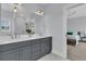 Bright bathroom features a double vanity, large mirror, and access to a bedroom at 1182 Welcome Dr Dr, Mount Pleasant, SC 29464