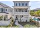 Charming two-story home with a double porch, American flag, landscaped yard, and Welcome Dr street sign at 1182 Welcome Dr Dr, Mount Pleasant, SC 29464