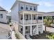 Inviting three-story home with a spacious balcony and a charming American flag at 1182 Welcome Dr Dr, Mount Pleasant, SC 29464