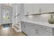 Hallway with custom cabinets, light hardwood floors, stairway, and bright entry at 1182 Welcome Dr Dr, Mount Pleasant, SC 29464