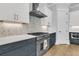 Modern kitchen featuring stainless steel appliances, custom cabinets, marble backsplash, and hardwood flooring at 1182 Welcome Dr Dr, Mount Pleasant, SC 29464