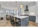 Spacious kitchen with seating at the large island with stainless appliances and marble backsplash at 1182 Welcome Dr Dr, Mount Pleasant, SC 29464
